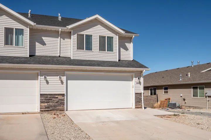 Two-story exterior with horizontal siding and stone accenting