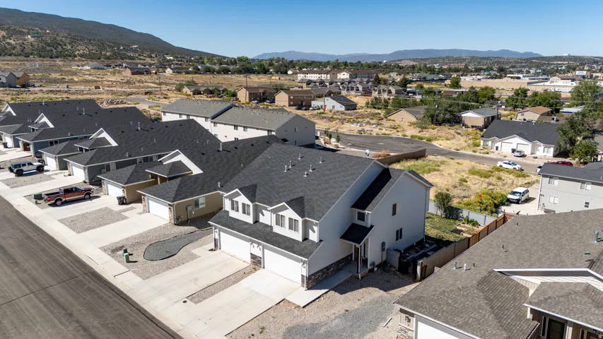Pitched roofs, attached garages, paved driveways, and landscaped rock beds