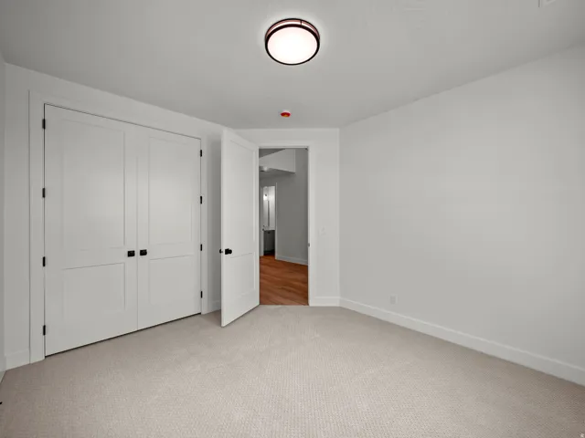 Light-toned carpeting and white walls