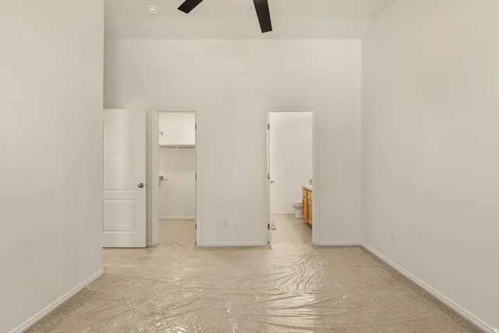 Vaulted ceilings and a ceiling fan enhance the bright interior