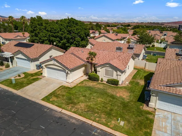 Single-story residence featuring a tile roof, stucco exterior, attached garage, and a concrete driveway