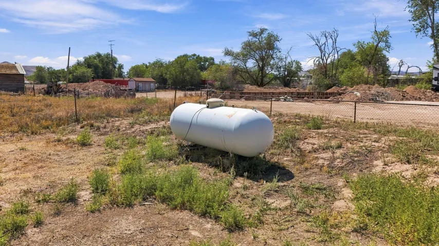 Propane tank within a fenced perimeter
