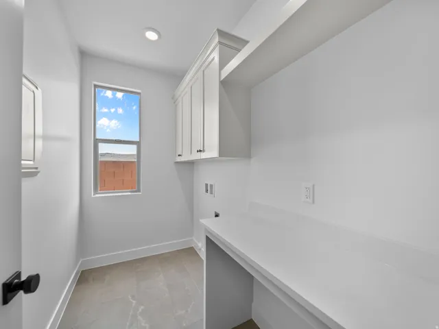 Recessed ceiling lighting, white shaker-style cabinetry, an integrated countertop, open shelving, and tile flooring