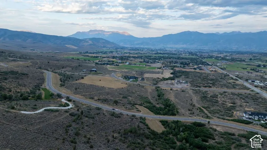 Winding paved roads traversing varied topography with distant mountain ranges