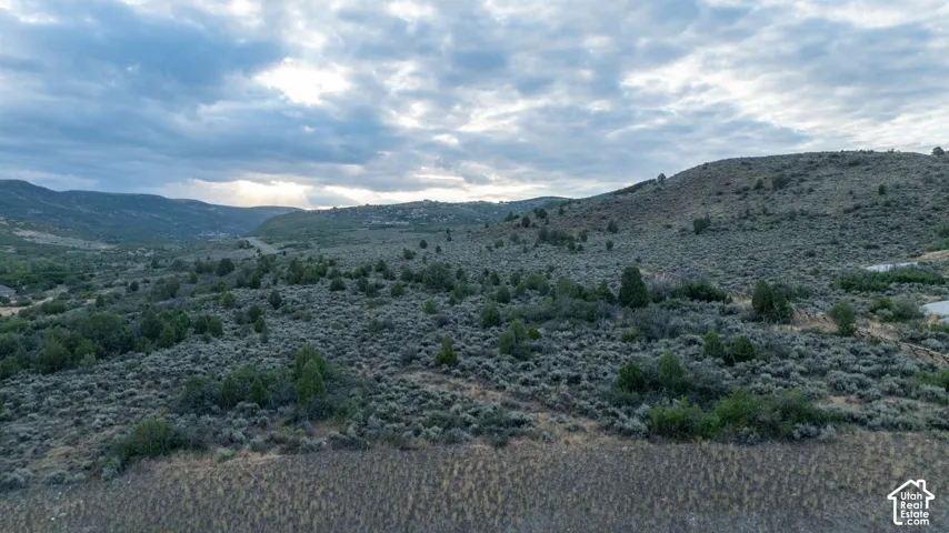 Expansive undeveloped land featuring natural terrain and distant mountains