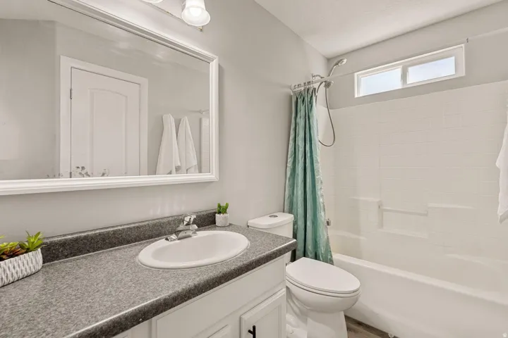 White vanity with an integrated sink and dark countertop