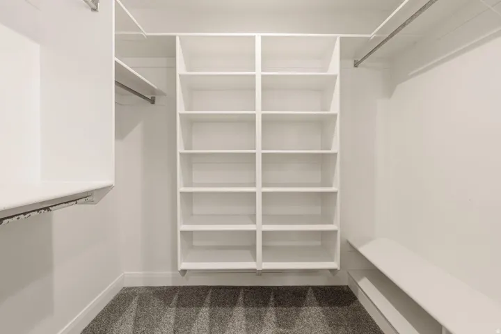 Built-in shelving, hanging rods, and a storage bench