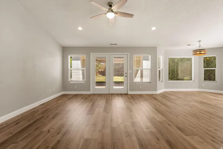 Wood-finish flooring throughout, complemented by light gray wall tones