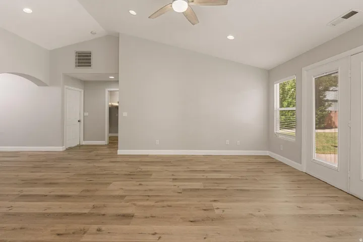 Vaulted ceiling with recessed lighting and ceiling fan