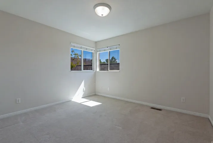 Neutral-toned walls complement plush carpeting