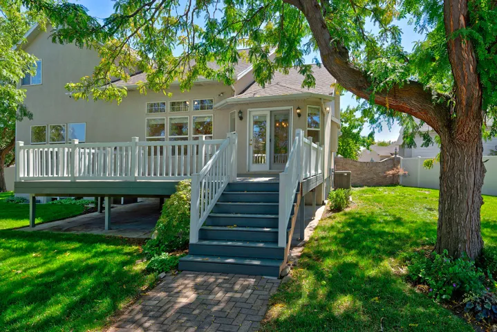 Expansive rear decking with white railings and dual access points