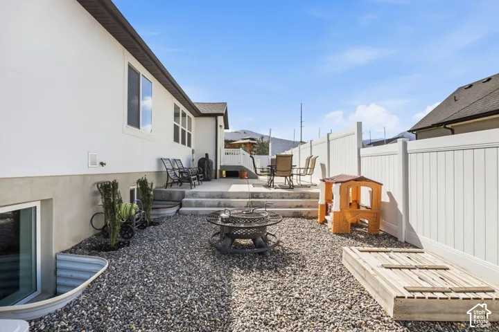 White stucco exterior with a gray-toned gravel yard