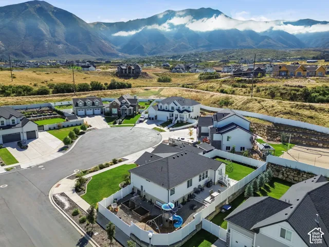 Mountain backdrop, cul-de-sac location, manicured lawns, fenced backyard, and established landscaping