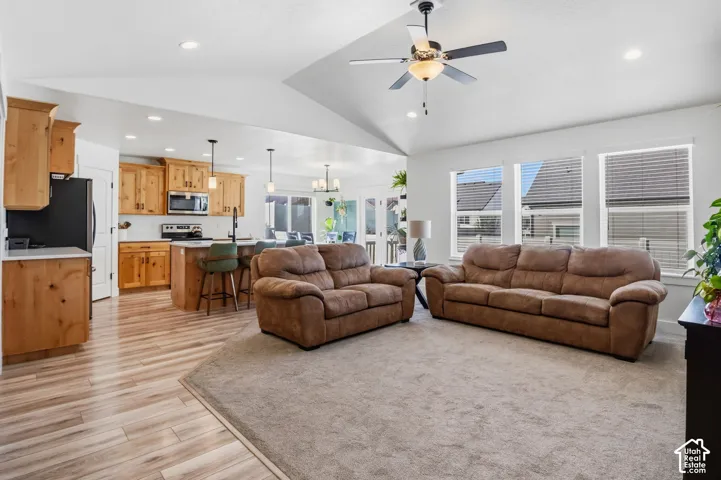 Vaulted ceiling with a ceiling fan and recessed lighting
