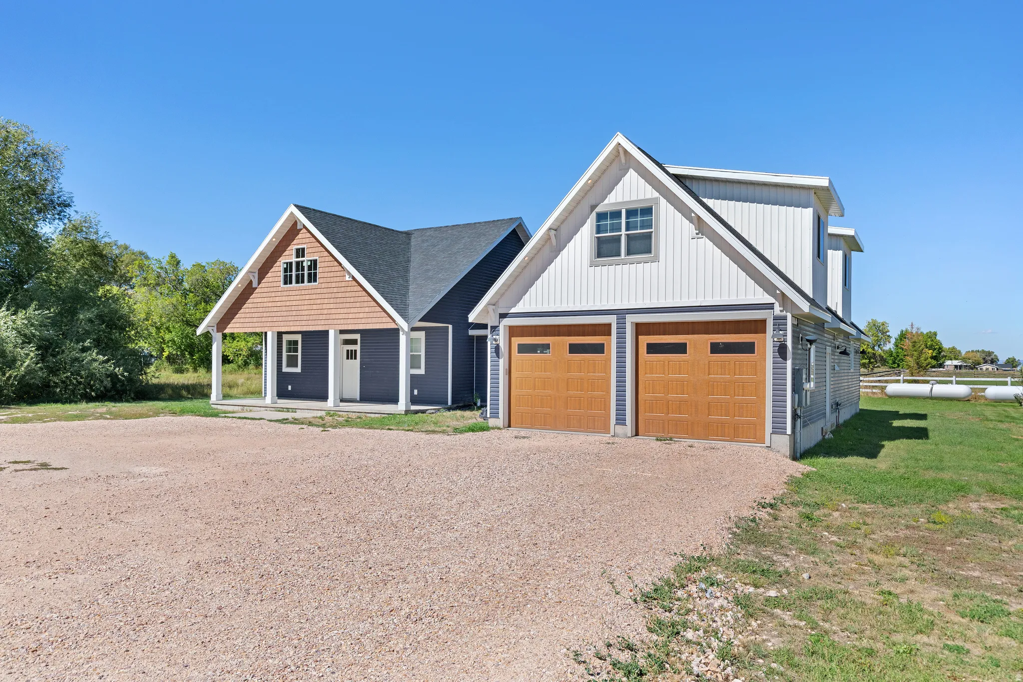 Two-car garage with wood-finish doors and upper-level window