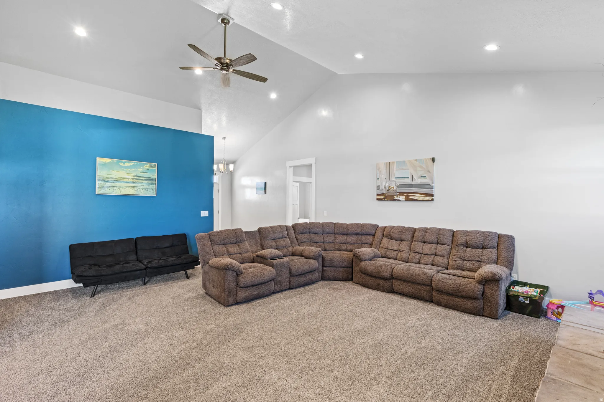Vaulted ceiling with a ceiling fan, recessed lighting, and a blue accent wall