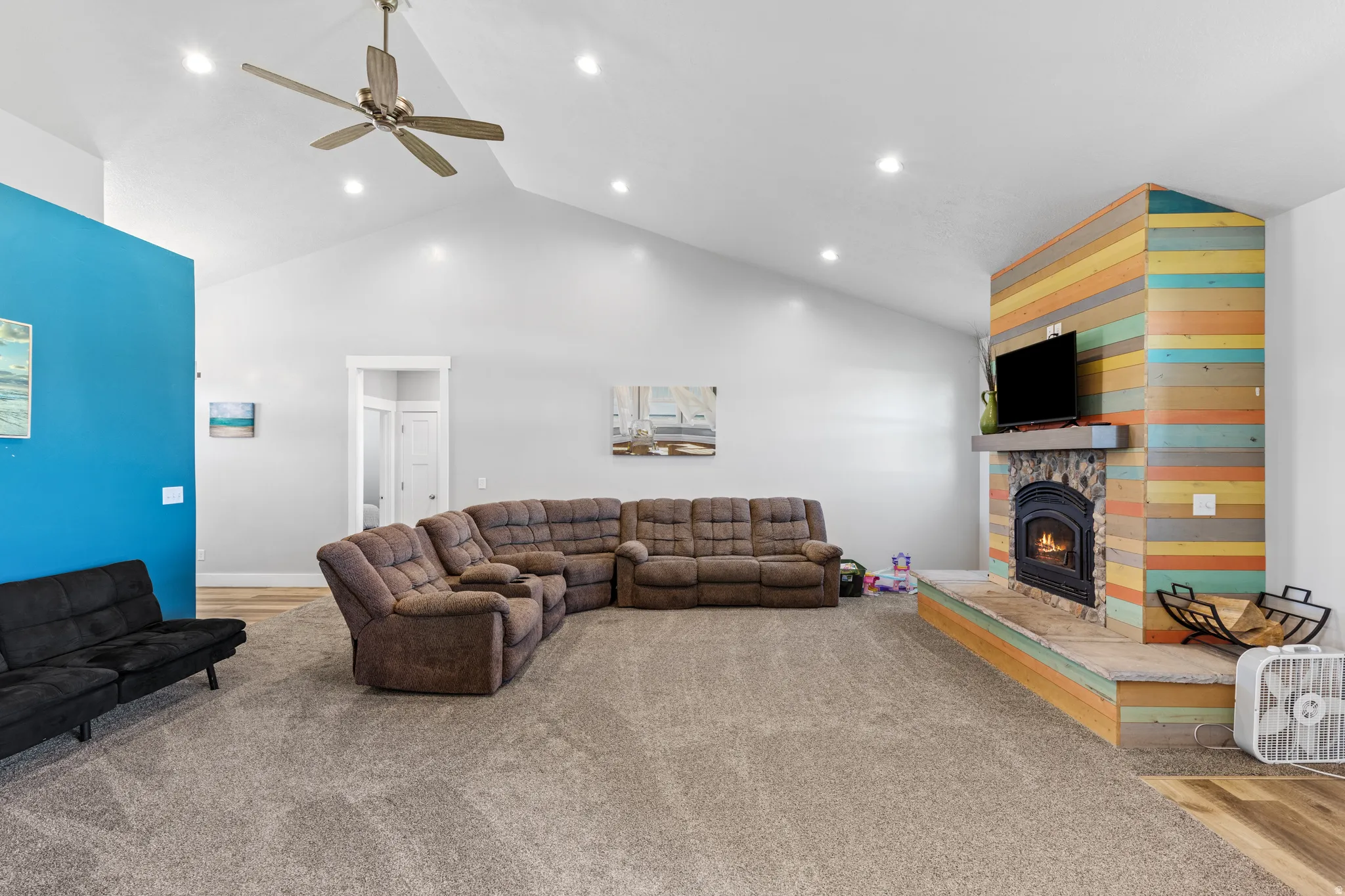 Vaulted ceilings with recessed lighting and a ceiling fan