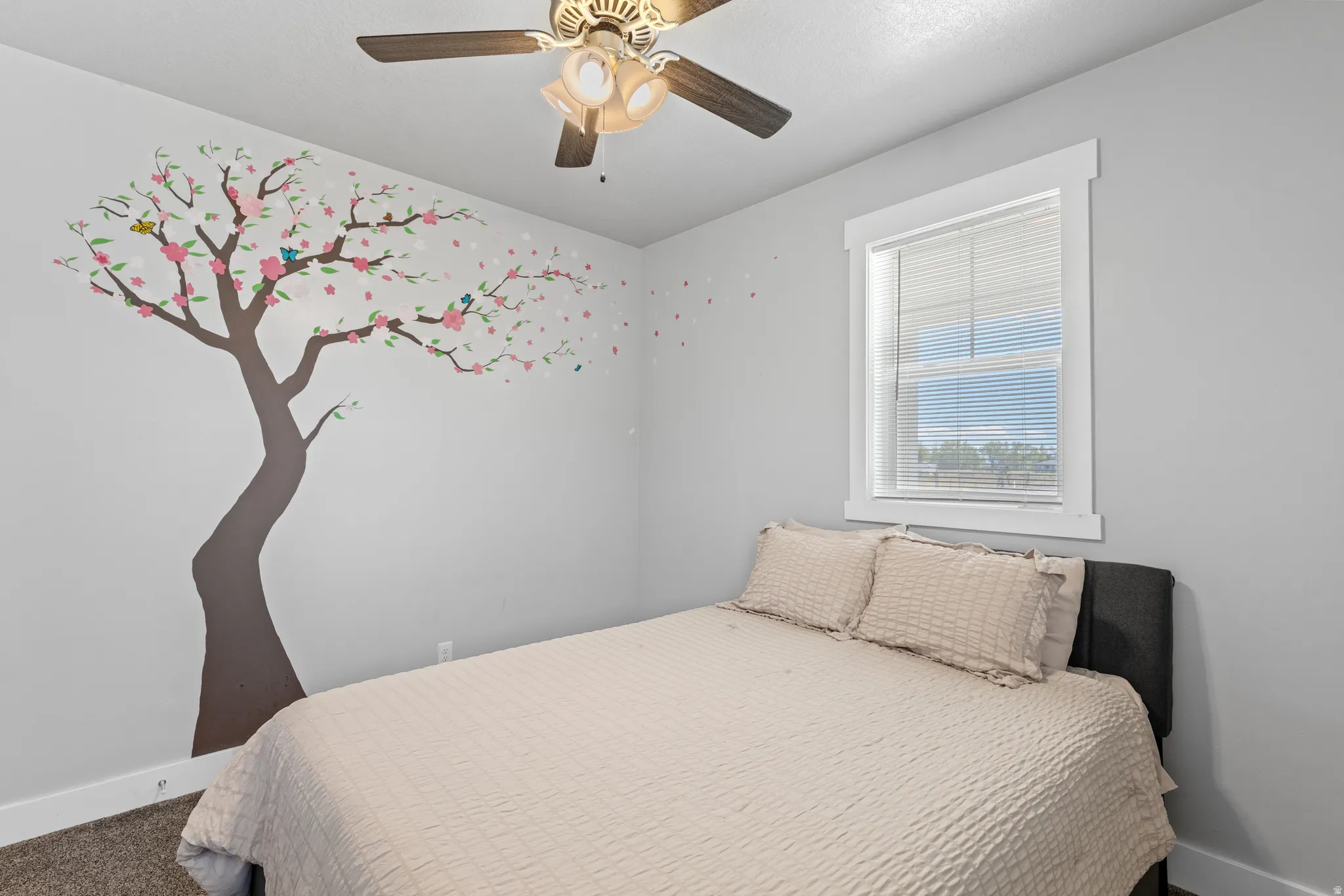 Light gray wall finish, white window trim, window blinds, ceiling fan, and carpeted flooring