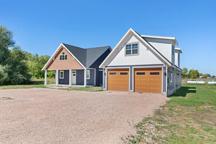 Two-car garage with wood-finish doors and upper-level window