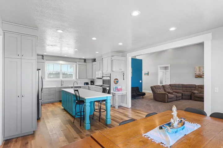 Wood-finish flooring, recessed lighting, and a bright kitchen window