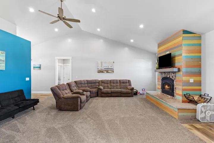 Vaulted ceilings with recessed lighting and a ceiling fan