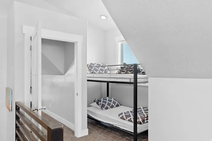 Carpeted room featuring a sloped ceiling and a recessed light