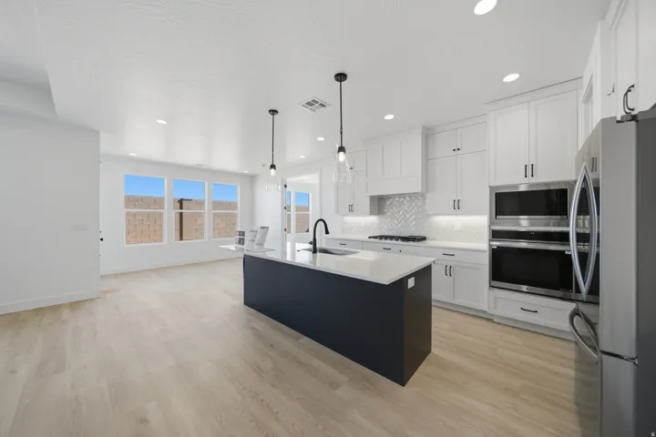 Light wood-finish flooring complements the white walls