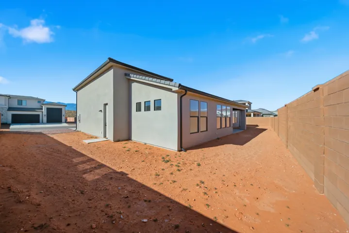 Stucco exterior with multiple windows and a flat roofline