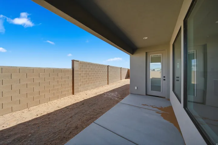 Covered patio with recessed lighting, large glass windows, and a glass-paneled door