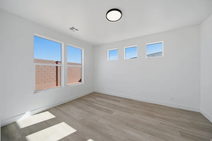 Recessed ceiling light fixture, wood-finish flooring, and multiple windows