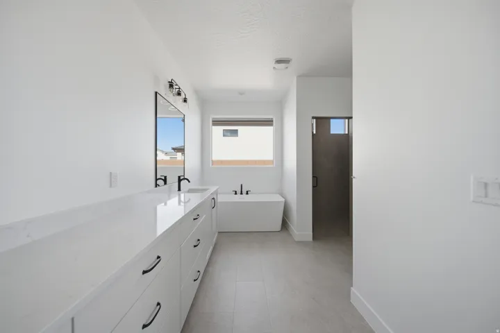 Dual vanity with white cabinetry and stone countertop