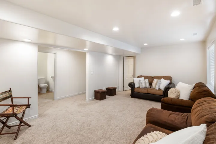 Recessed lighting illuminates the carpeted floor
