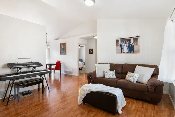 Laminate flooring throughout, vaulted ceiling, and recessed lighting
