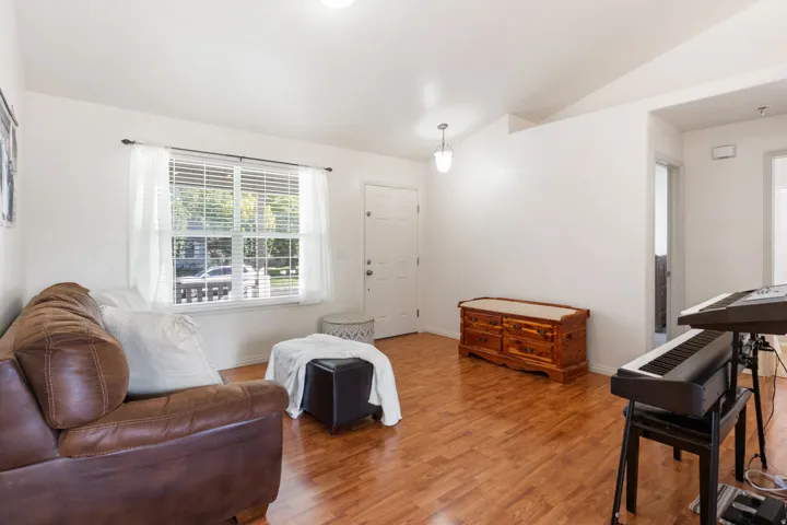 Laminate flooring throughout, bright white walls, and a recessed ceiling light