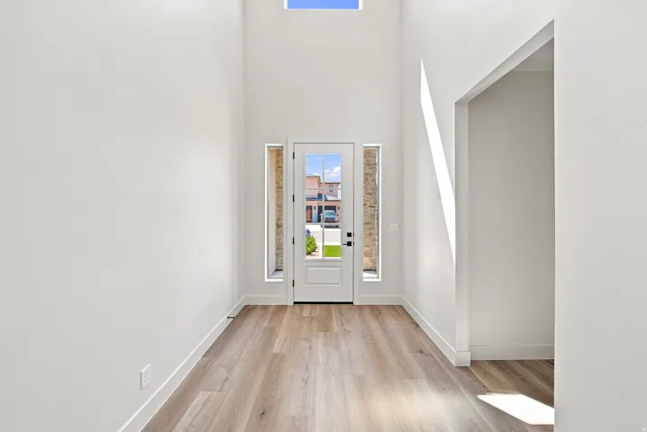 Double-height entry with wood-finish flooring