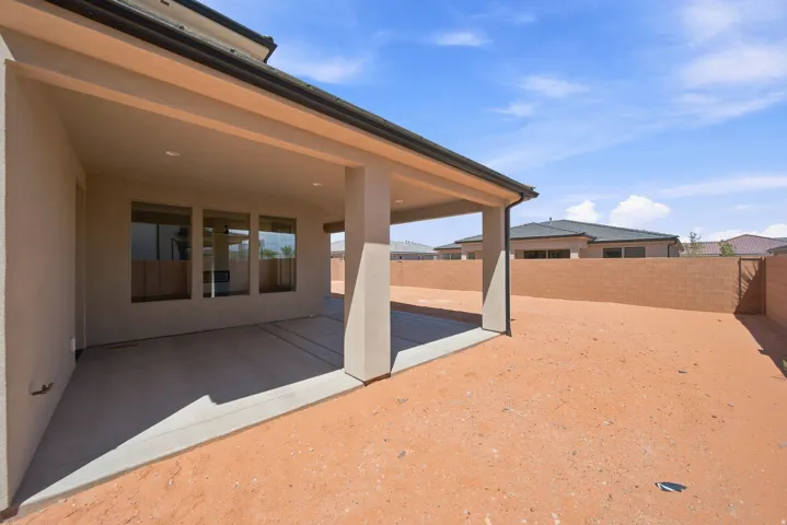Spacious covered patio with recessed lighting and concrete flooring