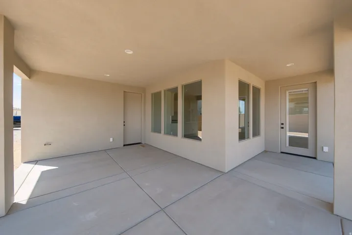Covered patio with concrete flooring, recessed lighting, and multiple window panels