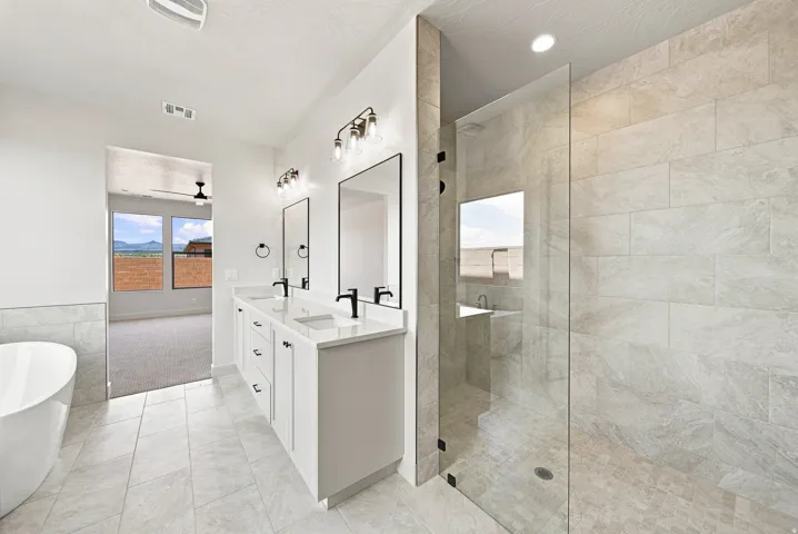 Dual vanity with white cabinetry, square undermount sinks, and matte black fixtures