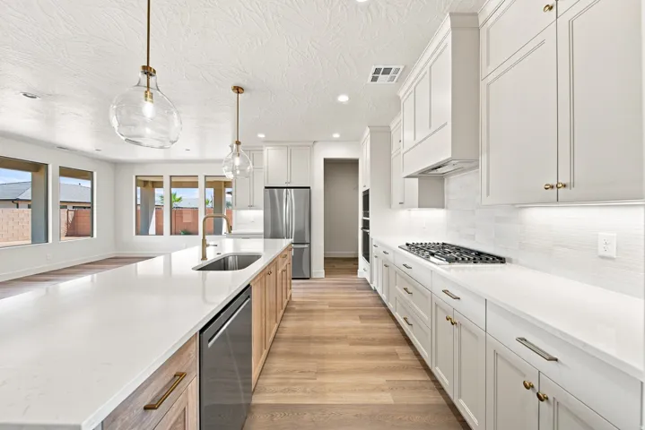 Modern kitchen featuring a gas range, stainless steel appliances, and a central island with an undermount sink