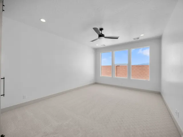 Recessed lighting, ceiling fan, triple windows, light-toned carpet, and contemporary baseboards