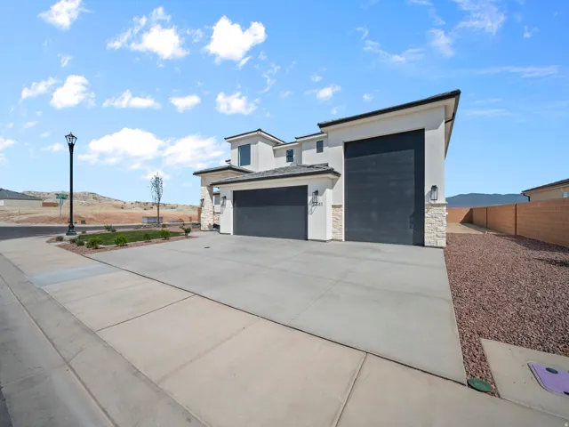 Contemporary architectural style with a stucco finish and stone accents