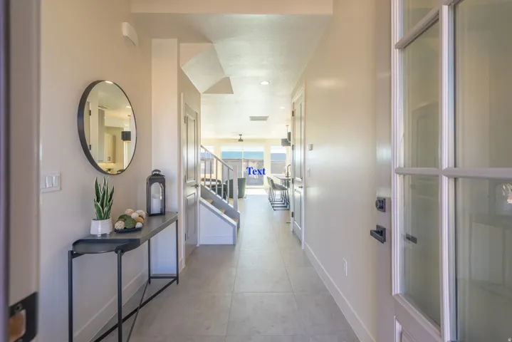 Bright hallway featuring polished concrete flooring, recessed ceiling lighting, and clean white walls