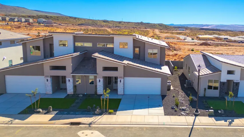 Modern residential development featuring contemporary architectural design with clean geometric lines, flat roofing, and expansive glazing