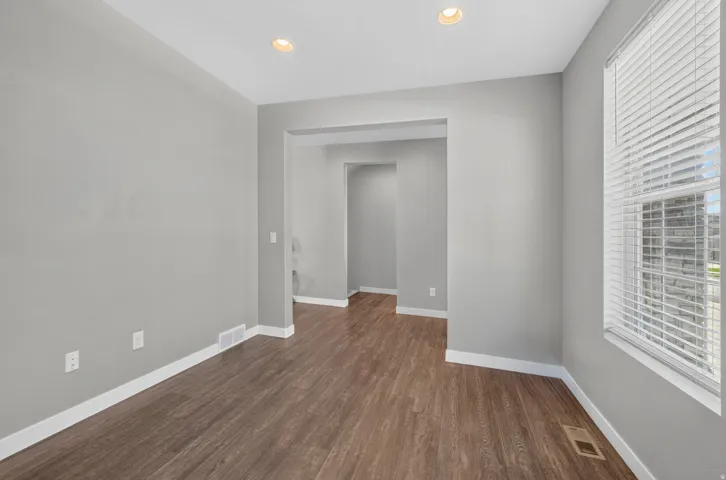 Wood-finish flooring, recessed lighting, and a window with blinds