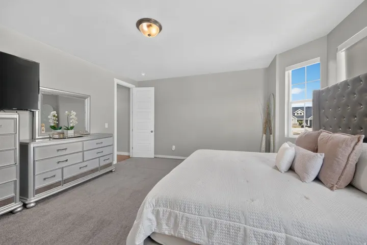 Carpeted flooring, neutral wall paint, and a built-in window