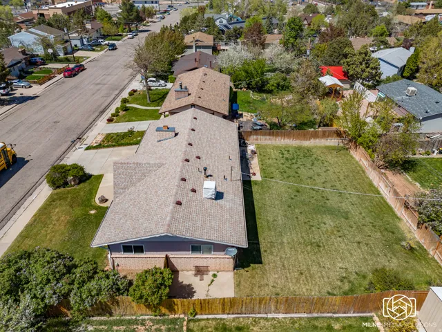 Spacious backyard with a wooden perimeter fence, offering a large grass area