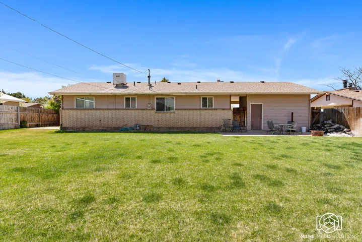 Expansive grassy yard with a concrete patio