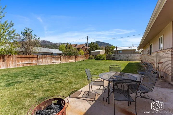 Expansive lawn area with a solid wood fence