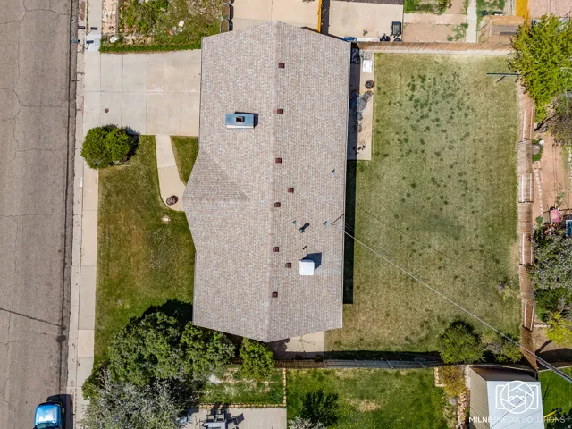 Gabled roofline, concrete driveway, front lawn, backyard lawn, fenced perimeter