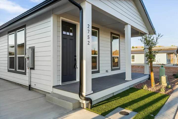 Contemporary exterior with light siding and dark trim
